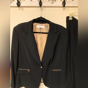 Tahari brand black suit w/ gold zippered pockets. Pants have a 2” cuff. Size 18w